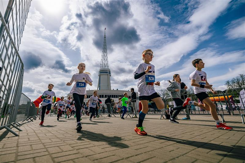 Grupa biegnących dzieci na terenie Międzynarodowych Targów Poznańskich